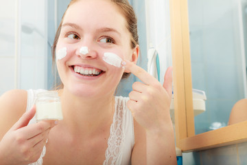 Woman applying moisturizing skin cream. Skincare.