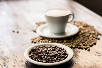 Still life of cappuccino cup and coffee beans