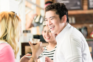 People having coffee and fun in Asian cafe