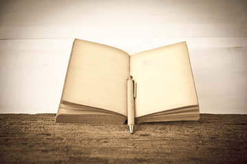 Stock Photo:.old book open blank pages, empty yellow paper on da
