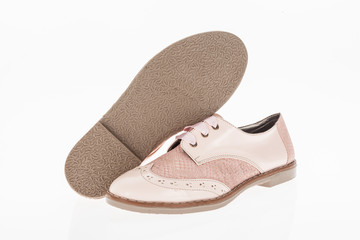  shoe made of pink leather with laces for women on white background