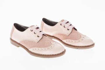  shoe made of pink leather with laces for women on white background