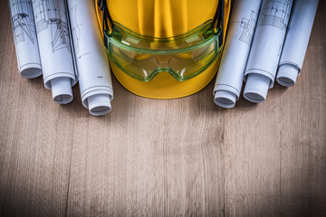 Protective glasses construction plans and building helmet on woo