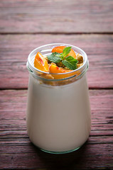 Thick Greek yogurt with granola, peaches and mint