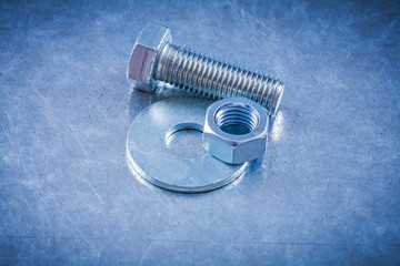 Stainless screwbolt bolt washer and screw-nut on metallic surfac