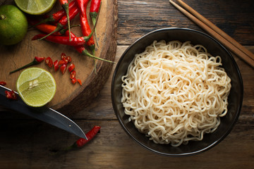 Instant noodles in white black on wood background