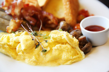 American Breakfast with bacon , scrambled egg on wood background