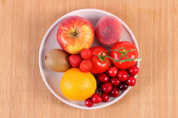 Fresh fruits and vegetables on plate, healthy nutrition