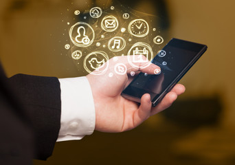 Hand holding smartphone with mobile app choices