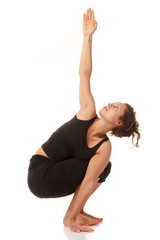 Fototapeta na wymiar Young woman doing yoga indoors