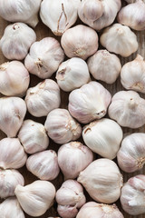 Garlic on wooden background, top view.