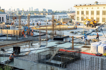 Construction site building in city center, bridge building at sunset