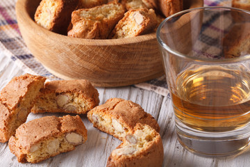 almond biscotti biscuits and sweet wine in a glass closeup. Horizontal
