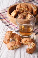 almond biscotti biscuits and sweet wine in a glass. vertical

