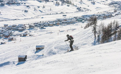 Fototapeta na wymiar Skier on the slope of Ski resort Livigno. Italy