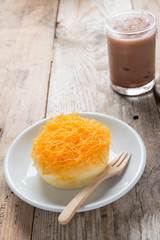 Foi thong cake with cool coco on wood table. Thai dessert.