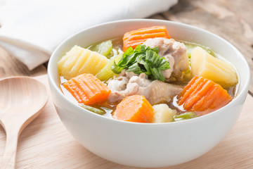 Chicken soup in white bowl.