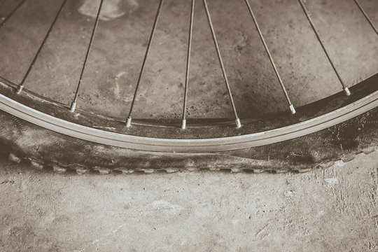 flat tire on dirt road with sepie tone