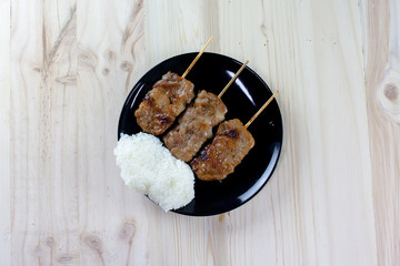 Thai-styled grilled pork and sticky rice. It's among most popular street foods in Thailand.