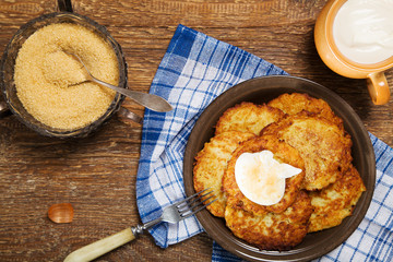 Homemade potato pancakes served with sour cream and brown sugar
