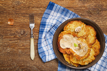Homemade potato pancakes served with mushroom sauce and mushroom