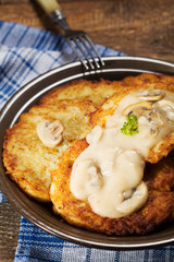 Homemade potato pancakes served with mushroom sauce and mushroom