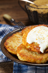 Homemade potato pancakes served with sour cream and brown sugar