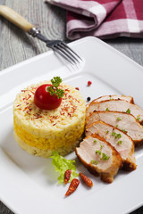 Portion of risotto with roasted chicken.