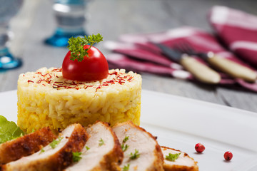 Portion of risotto with roasted chicken.