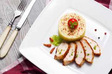 Portion of risotto with roasted chicken.