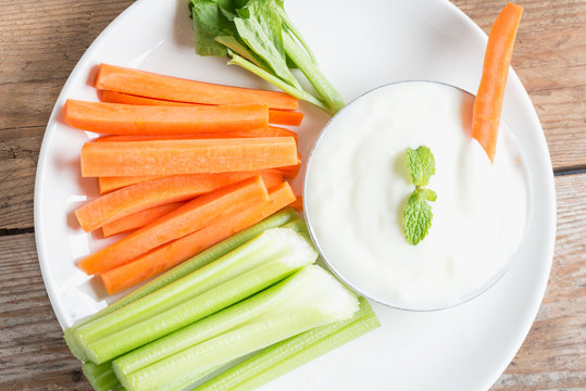 Vegetable sticks. Fresh celery and carrot with yogurt sauce.