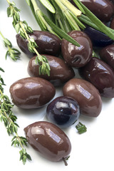 Kalamata, aromatic black olive from Greece with herbs on a white