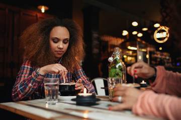 Girl stirring coffee in a cafe