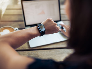 Woman checking time on her smartwatch