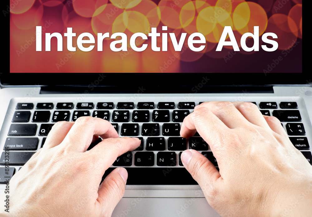 Poster interactive ads word on laptop screen with hand type on keyboard