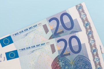 Two twenty euro notes on light blue background