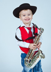 The little boy on a white background with a saxophone on the han