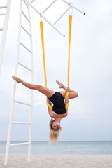 Young woman doing yoga exercise. Yoga with hammock. A