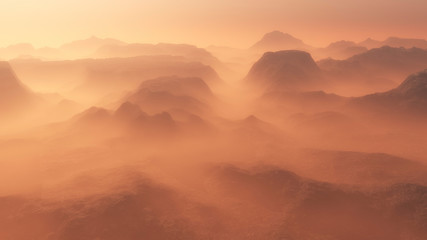 Mountain range glowing in the mist at sunrise. Aerial view.