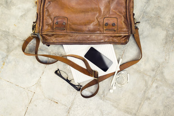 brown leather handbag, cell phone, diary and glasses