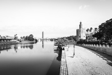 Guadalquivir River in Seville. Famous Golden Tower in the right. Black and white.