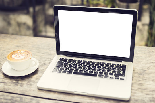 Blank laptop and cup of coffee outdoors, mock up
