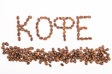 Composition of roasted coffee beans close-up on a white backgrou