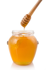 Honey dripping into a jar
