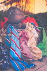 Vintage puppetts,colorful cloths and mask in the garden.