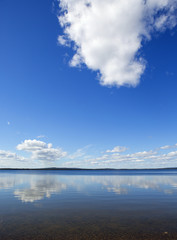 A beautiful scene in Finland in the summer time. Some clouds in the sky giving a deep contrast to the image.