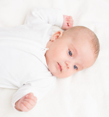 Cute little baby on the bed.