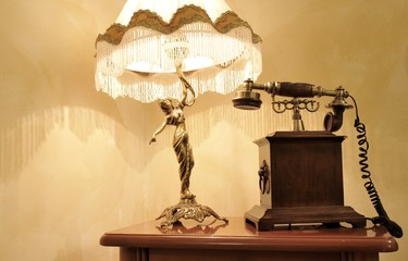 Vintage theme with antique lampshade and retro telephone