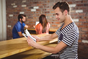  Young man reading a newspaper