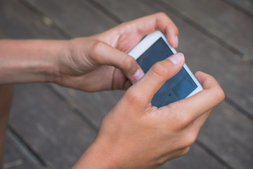 Close up on the hands of a a boy with a mobile phone
